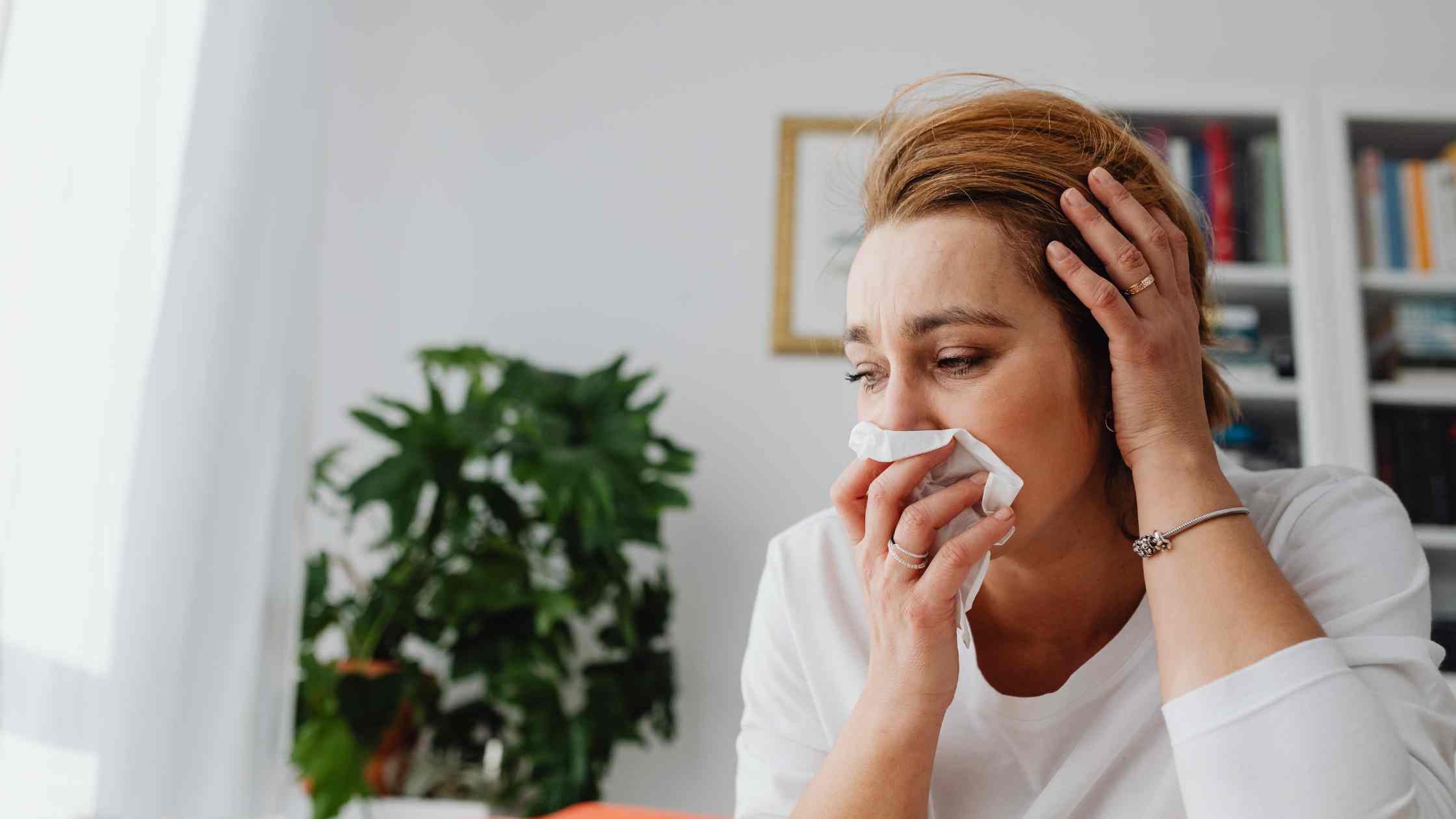 women with runny nose using kleenex by apothecary brands